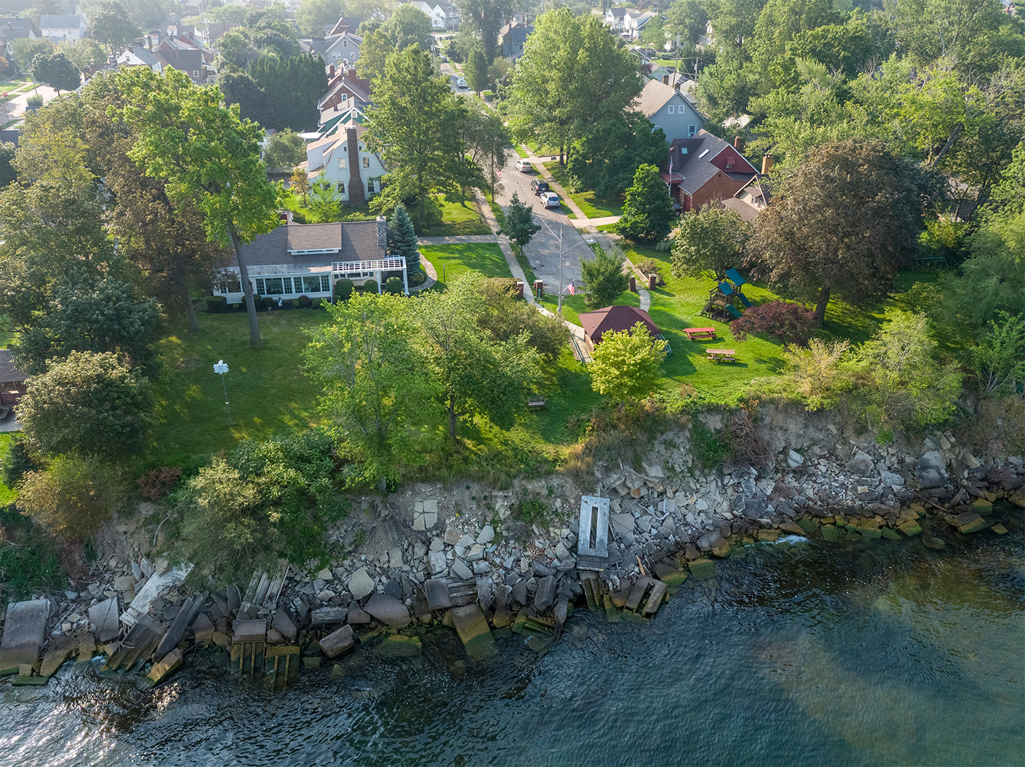 Aerial photo showing construction debris dumped along the shoreline in an attempt to slow the erosion