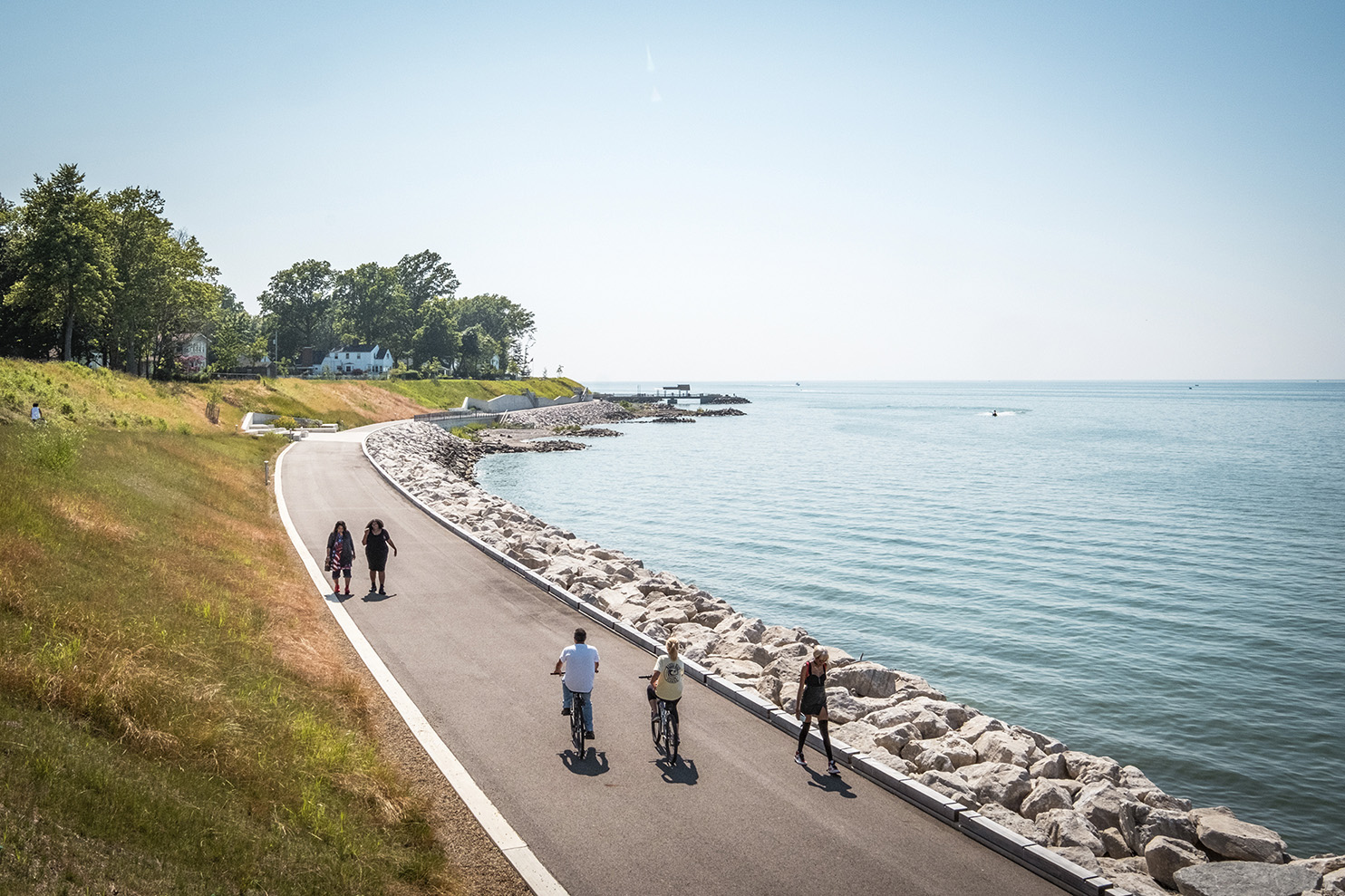 Photo showing walkers and bikers enjoying Euclid's completed waterfront trail on a sunny day.