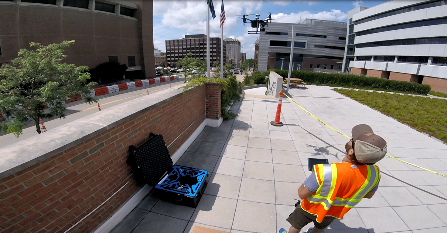 Photograph of Keenan Gibbons conducting a drone flight in downtown Ann Arbor, Michigan