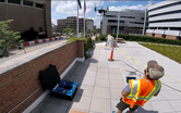 Photograph of Keenan Gibbons conducting a drone flight in downtown Ann Arbor, Michigan